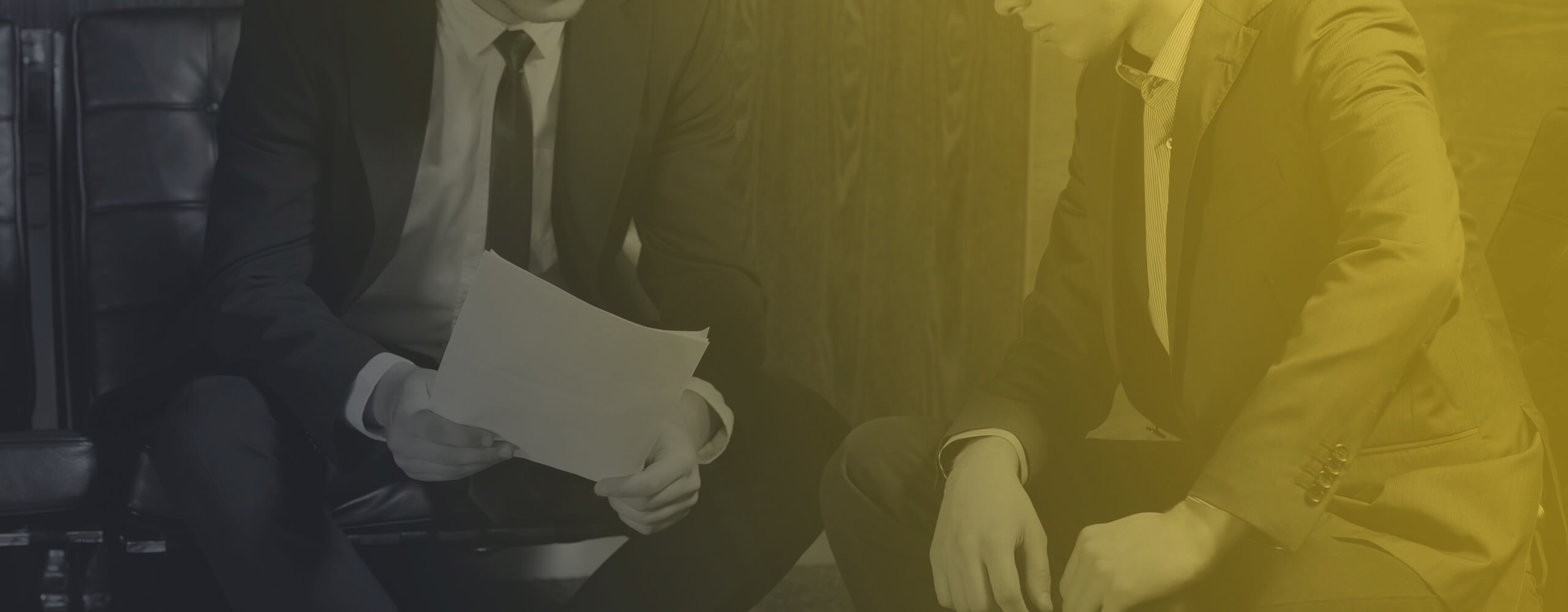 Image of two businessmen reading a memo